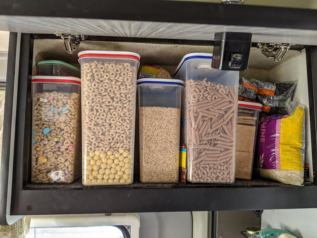 Overhead bin with containers of dry cereal 