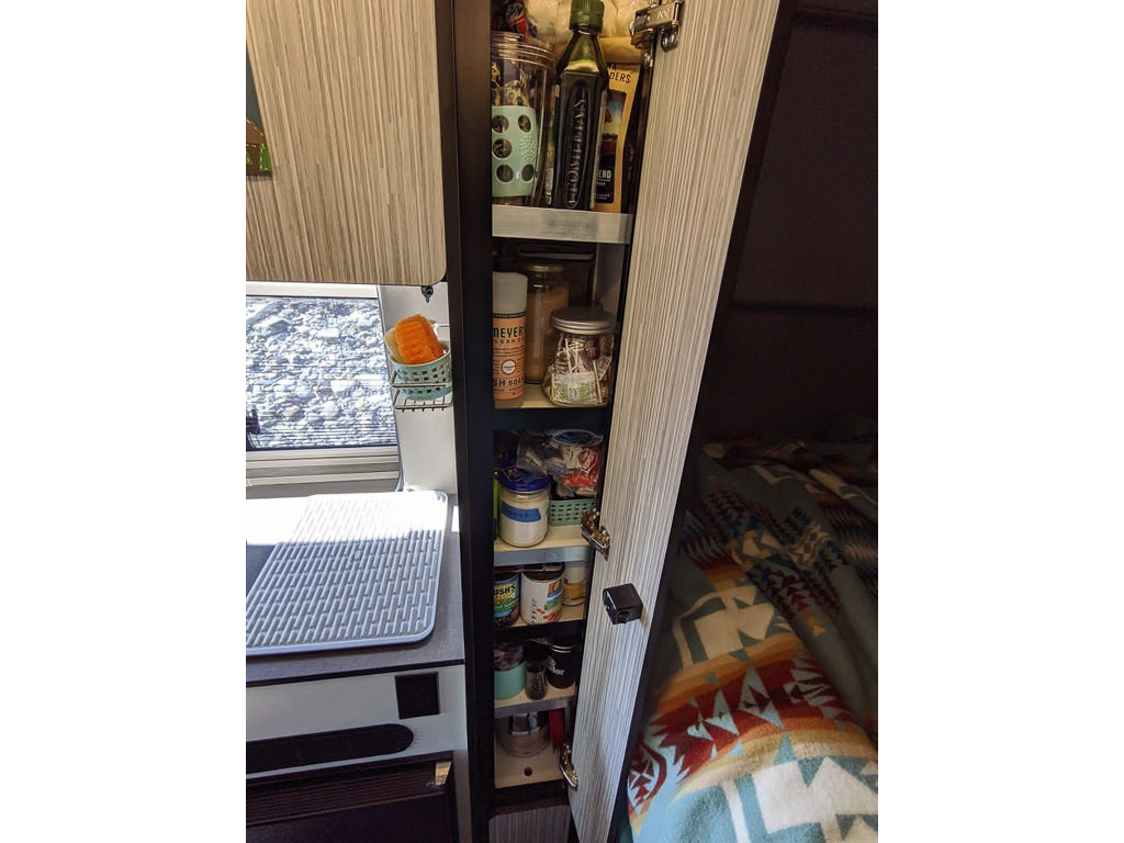 Pantry with three shelves full of food