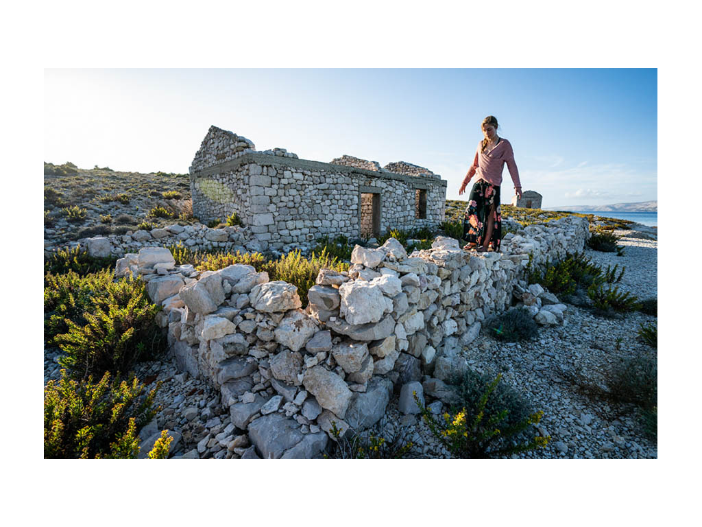 Abby walking on rocks of ruins of Sveti Grgur