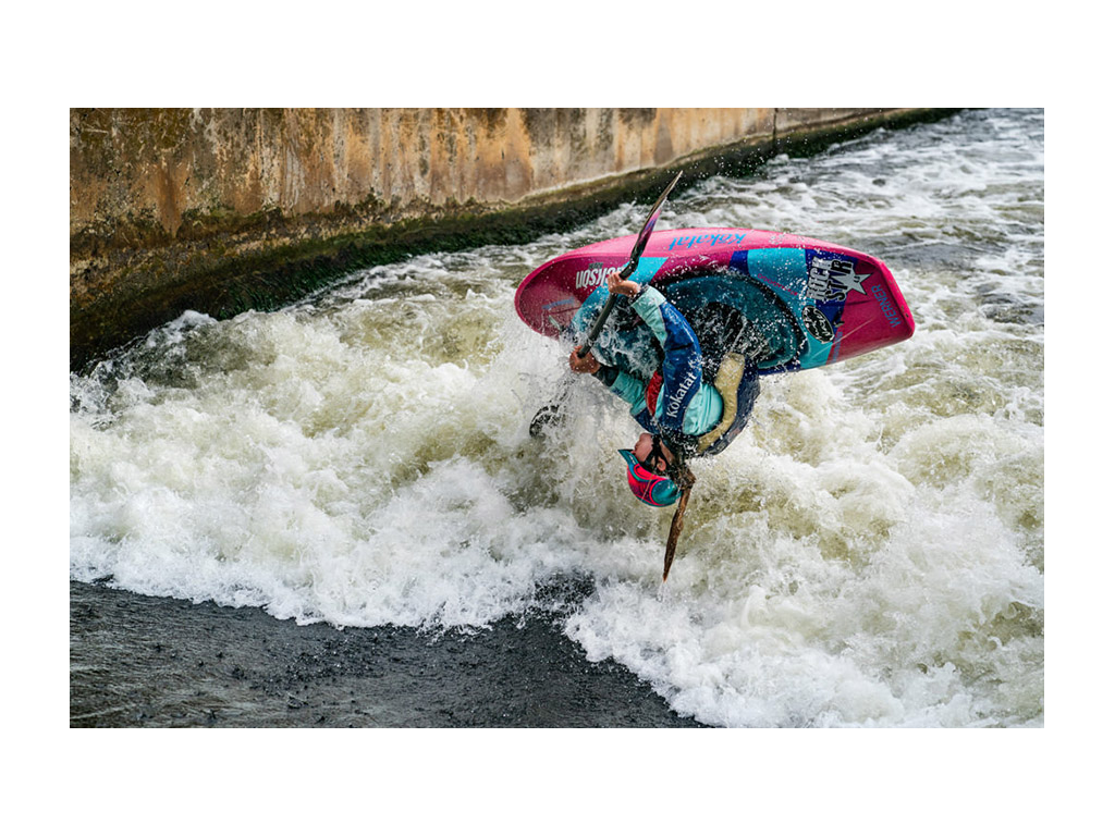 Abby in kayak flipping upside down in air