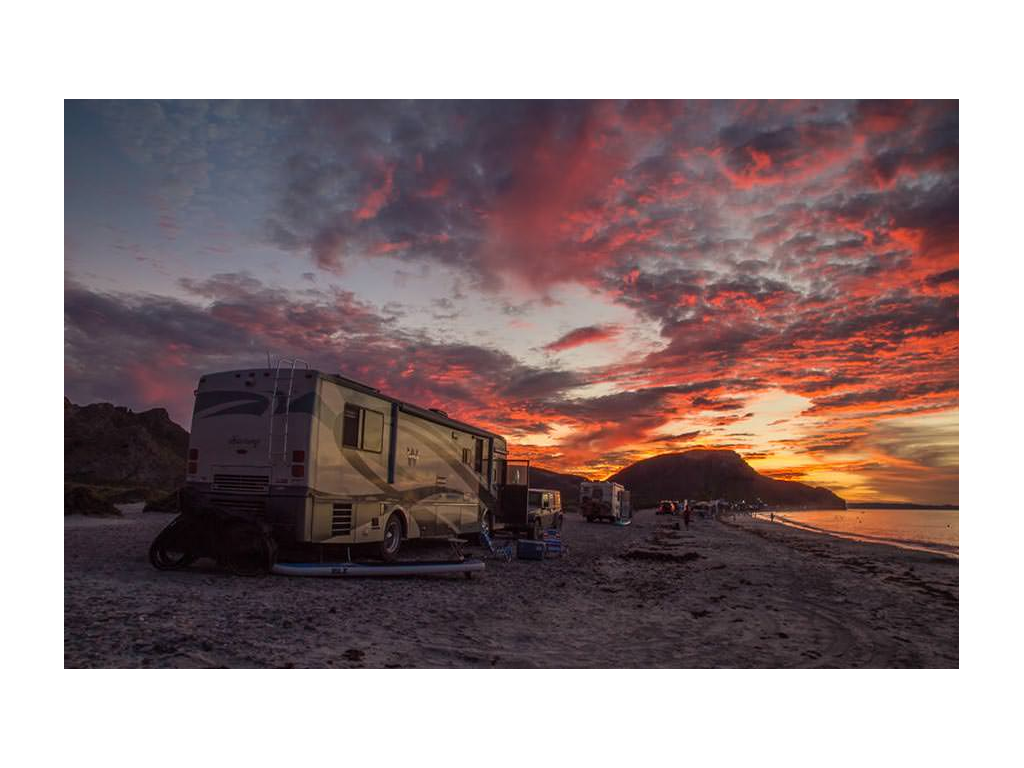 Winnebago Journey parked on beach during sunset
