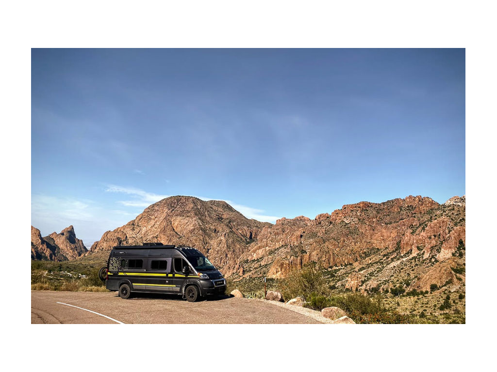Winnebago Travato parked next to mountains in Big Bend National Park