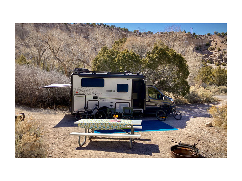 Winnebago EKKO parked in desert next to picnic table