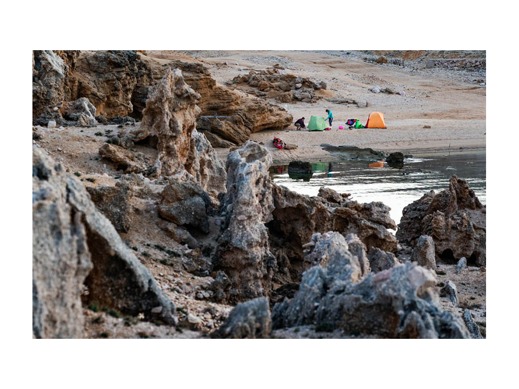 Abby and Kathy setting up tents at campsite near water