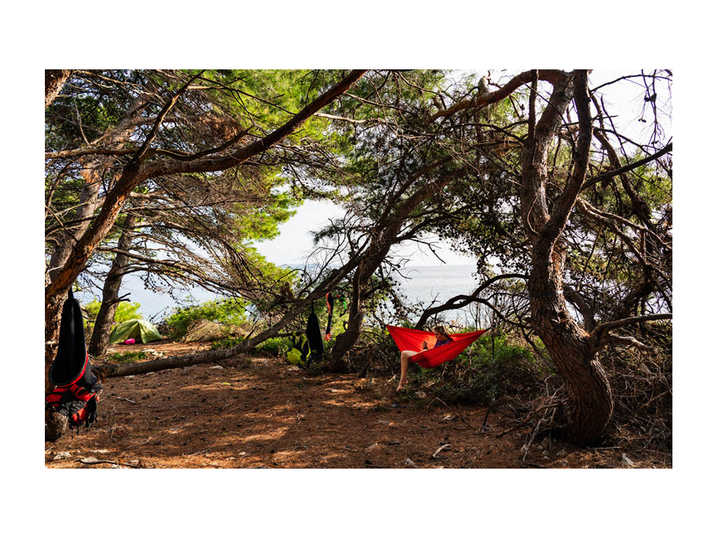 Abby sitting in hammock at campsite