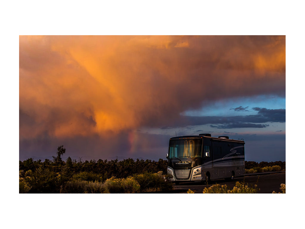Winnebago Adventurer parked with magnificent sunset in background