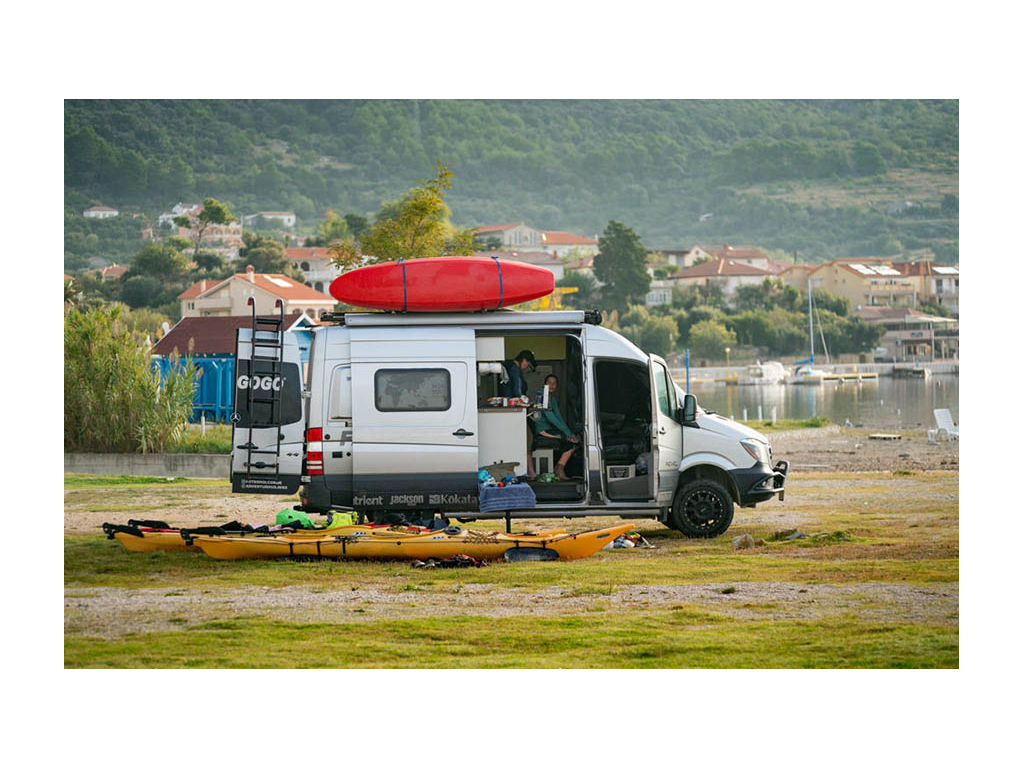 Abby and Kathy sitting in Revel with kayaks outside preparing for kayak trip
