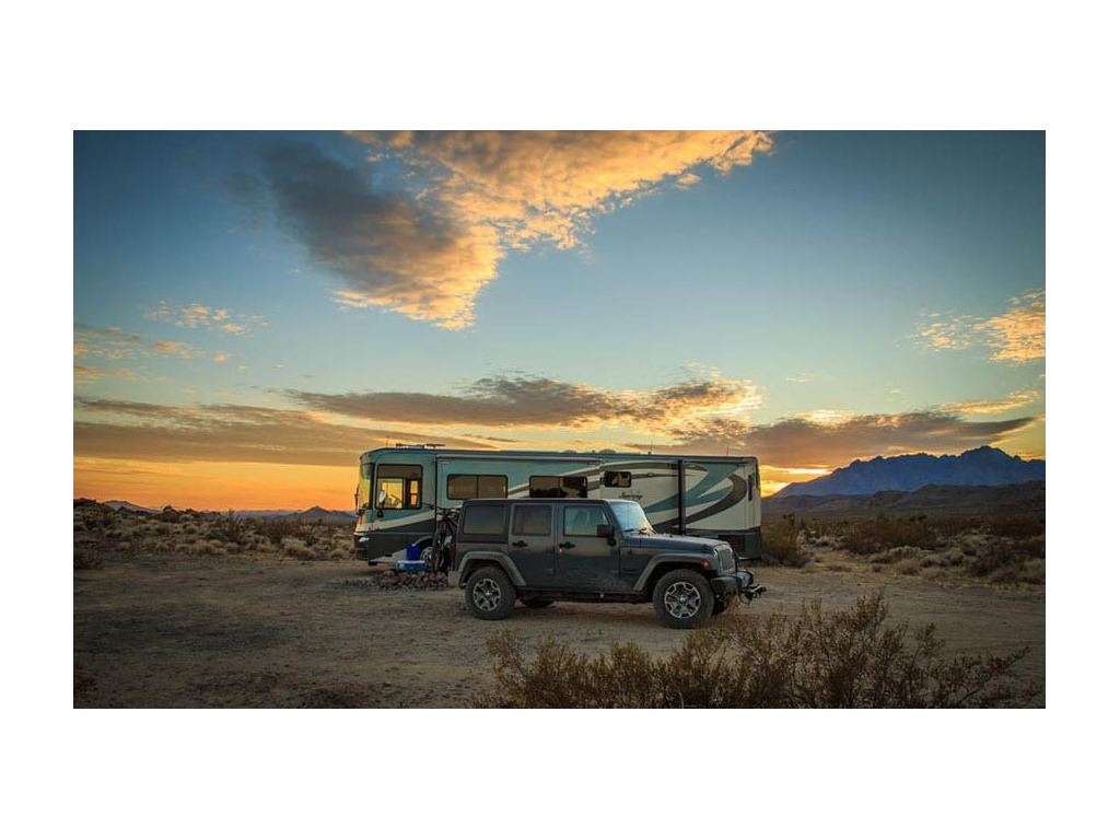 Journey and tow can parked in rocky desert