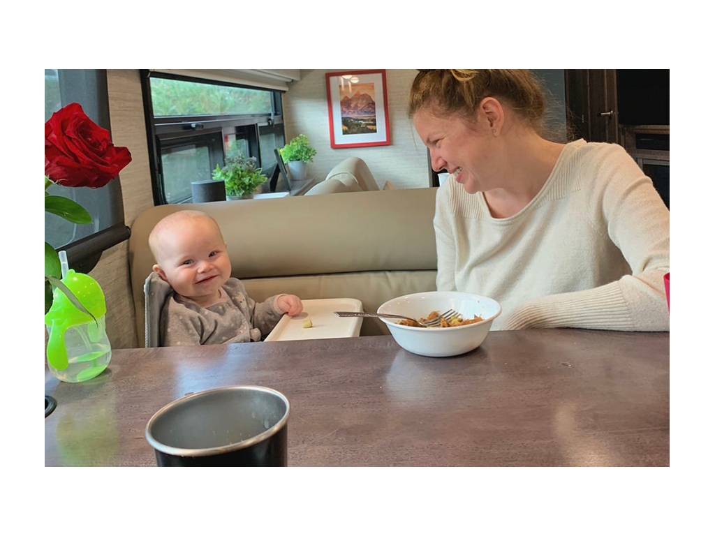 Alyssa and Ellie smiling while eating at dinette