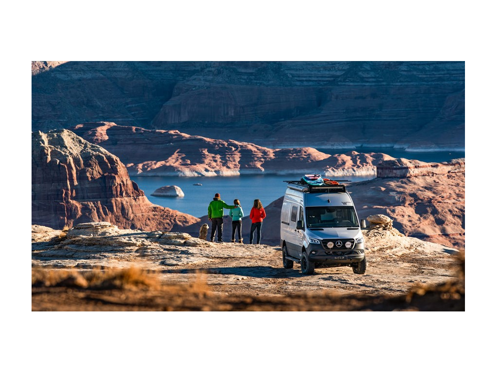 Holcombe family looking over mountain at water with Revel behind them
