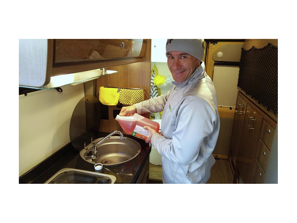 James pouring anti-freeze down sink