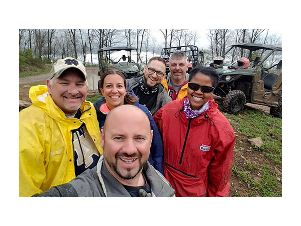 Sabrina and Kenny smiling for photo with four friends
