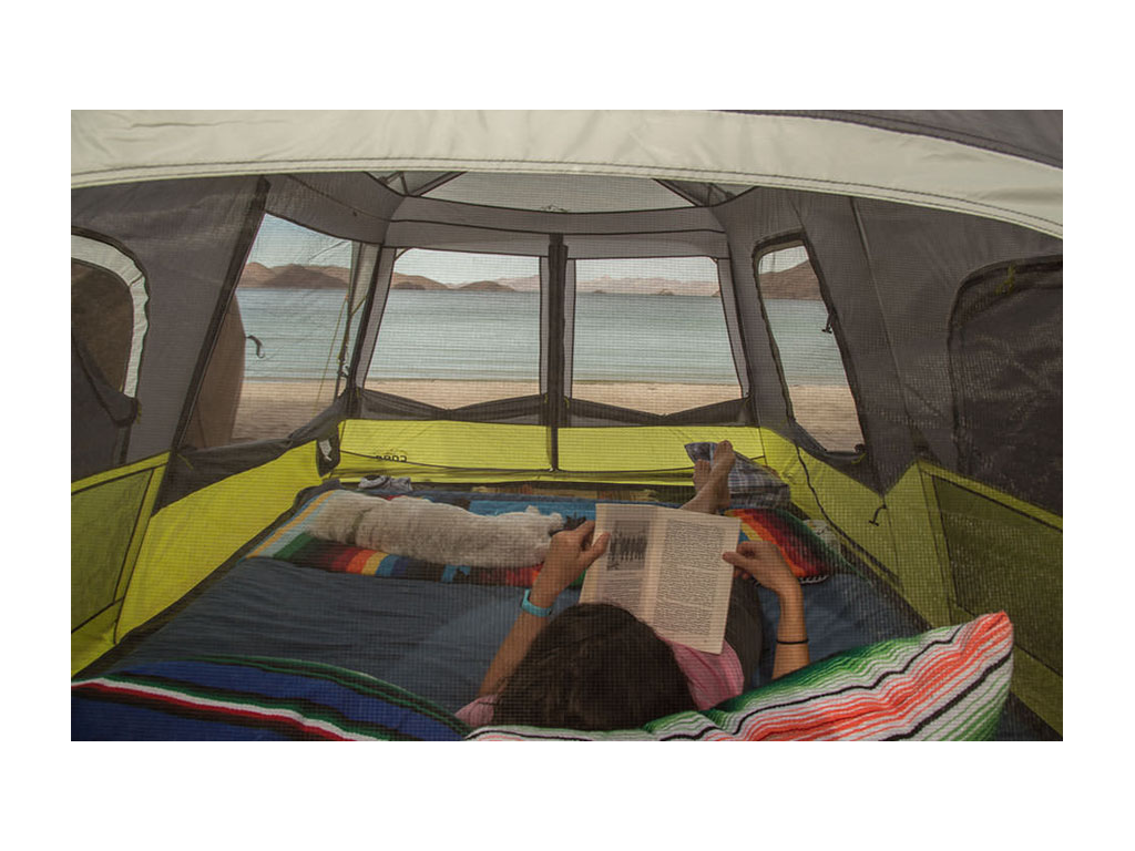 Jaime reading on bed inside tent