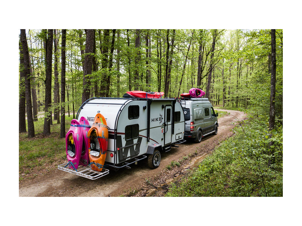 Winnebago Revel pulling Winnebago HIKE with six kayaks attached