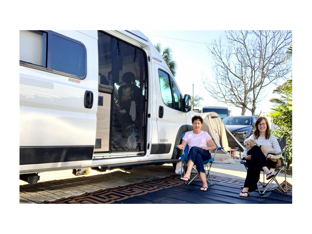 Lindsey and mom sitting outside of Winnebago Solis