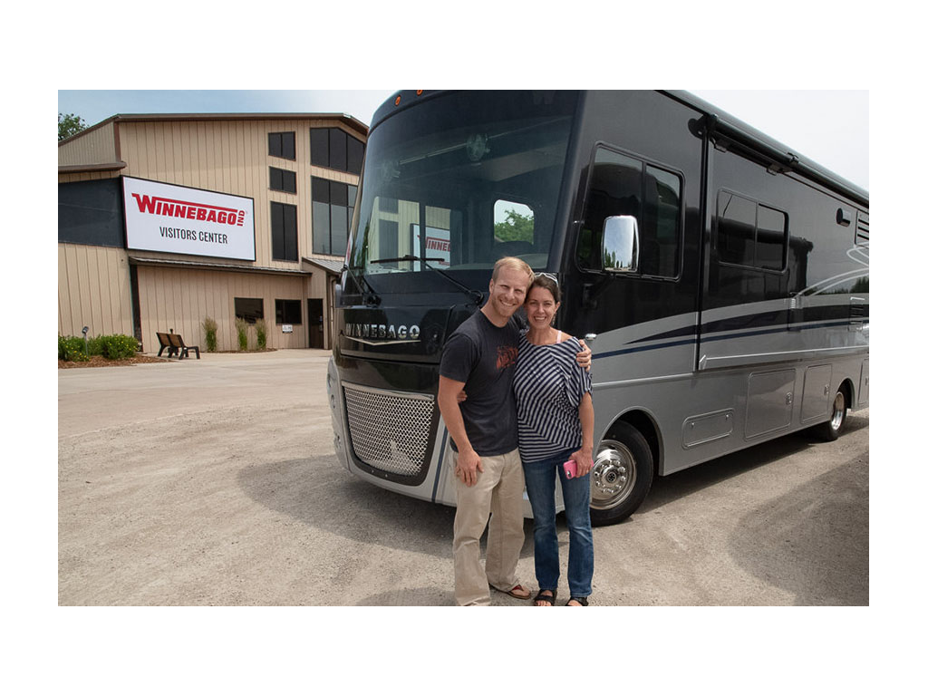 The Pyke's picking up their Winnebago Adventurer in front of the Winnebago Visitors Center
