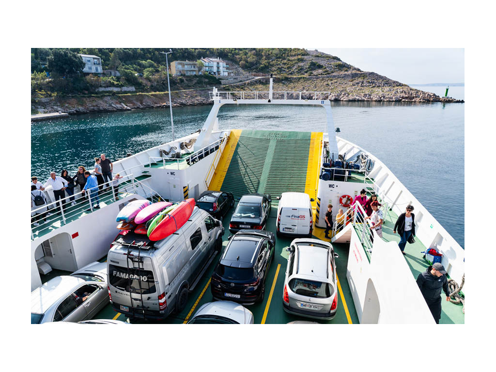 Revel traveling on a ferry with cars around it