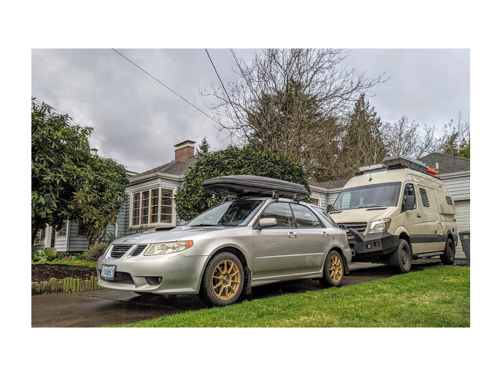 Revel parked behind small car to show size comparison