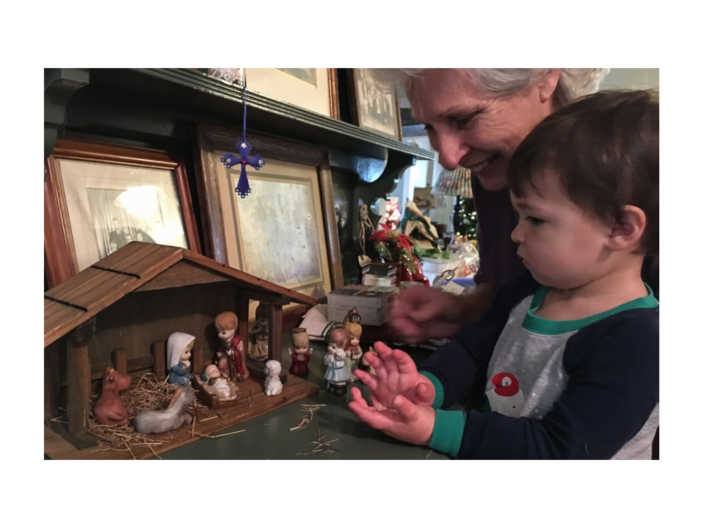 Caspian and Grandma looking at nativity scene