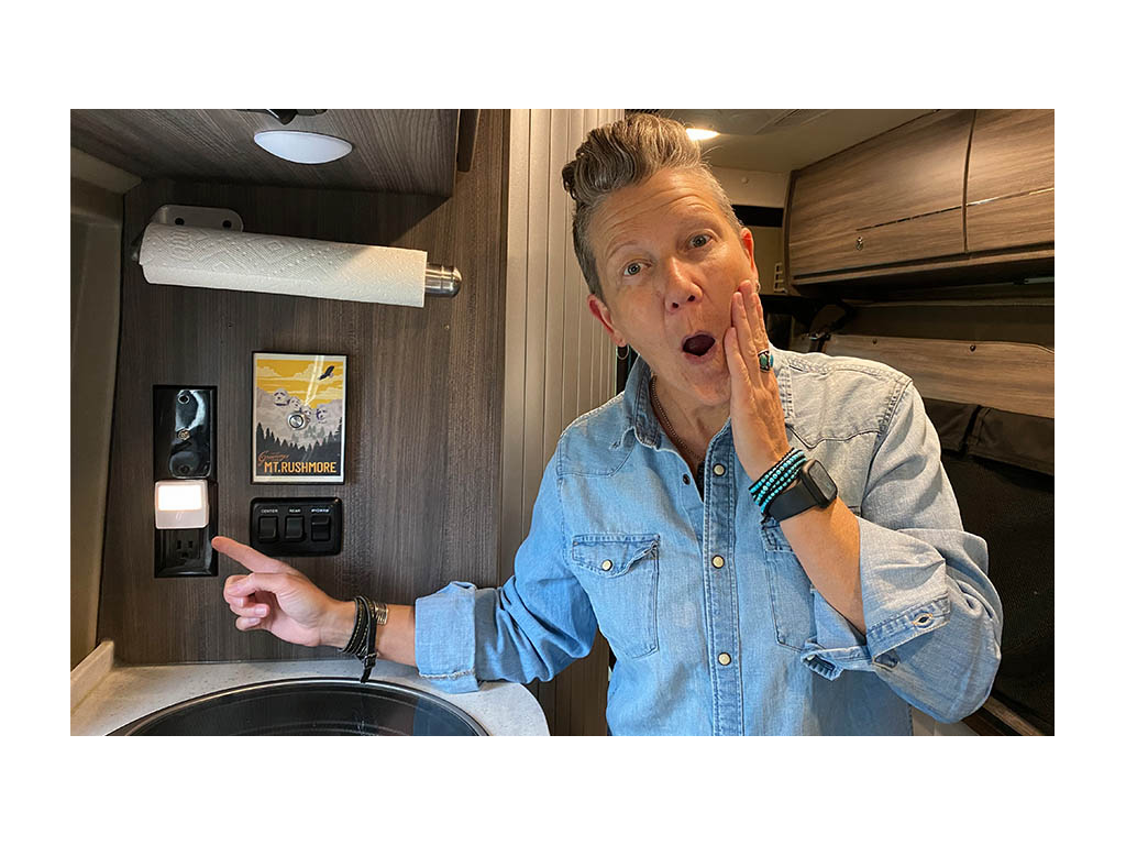 Noel pointing at night light in Travato