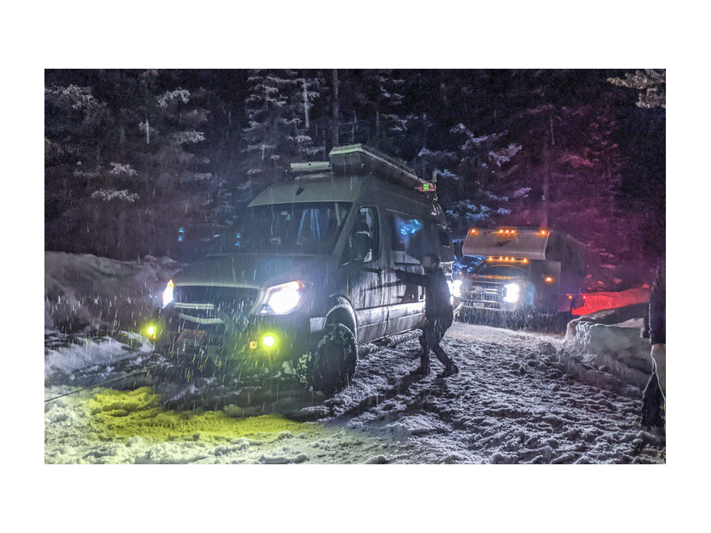 Gnar Wagon pulling out another RV at night in the snow