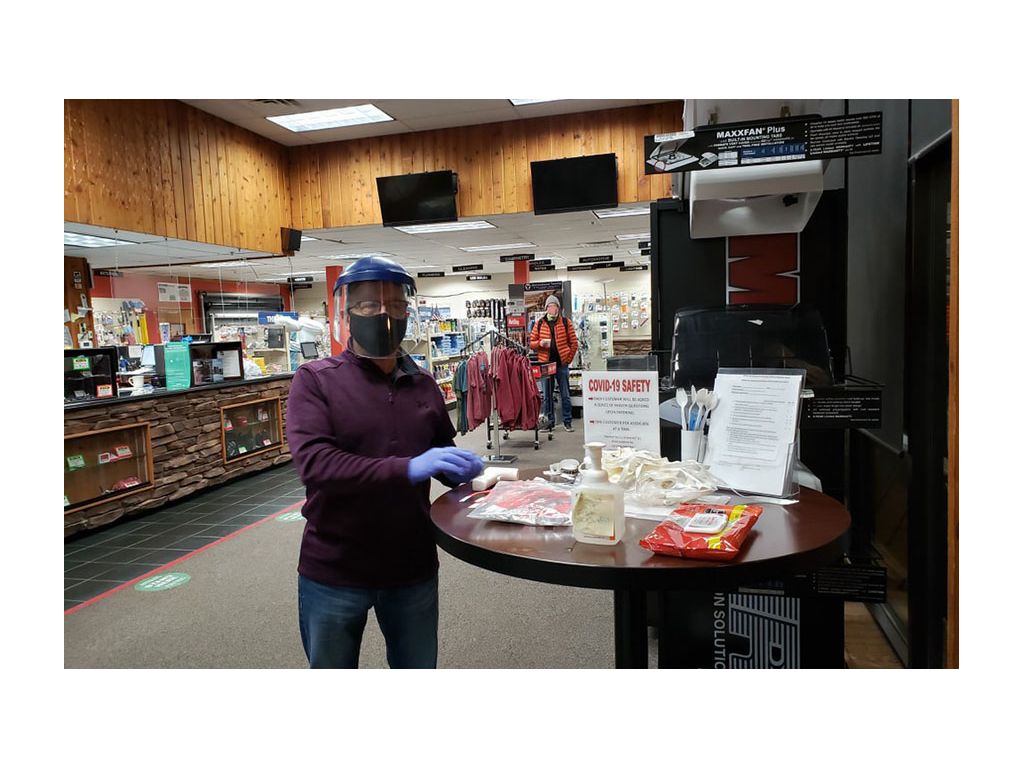 Check in station inside Factory Service Center with Covid safety rules, sanitizer, and masks