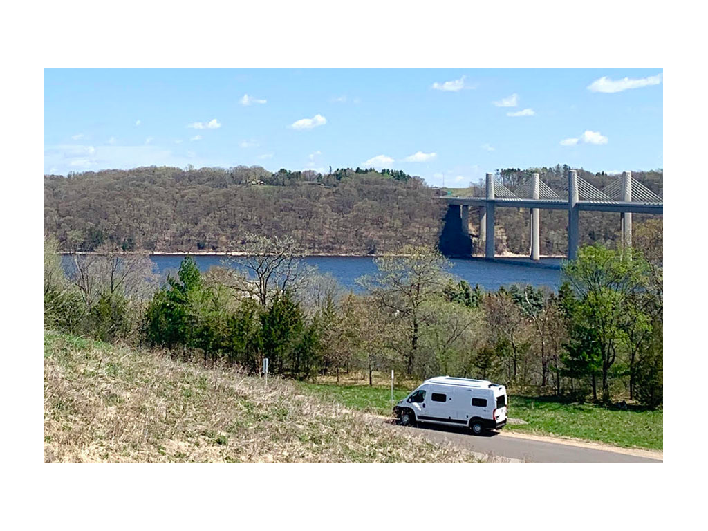 Solis driving down road in Stillwater, MN with bridge and water in background