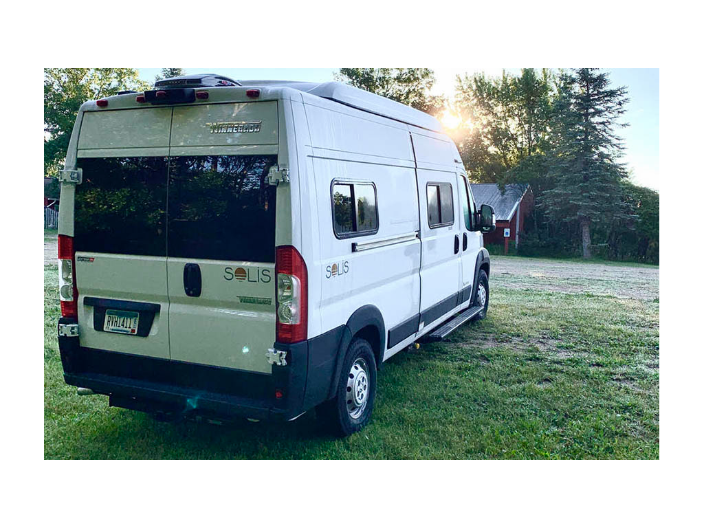 Side shot of Solis from rear with sun peeking out behind trees