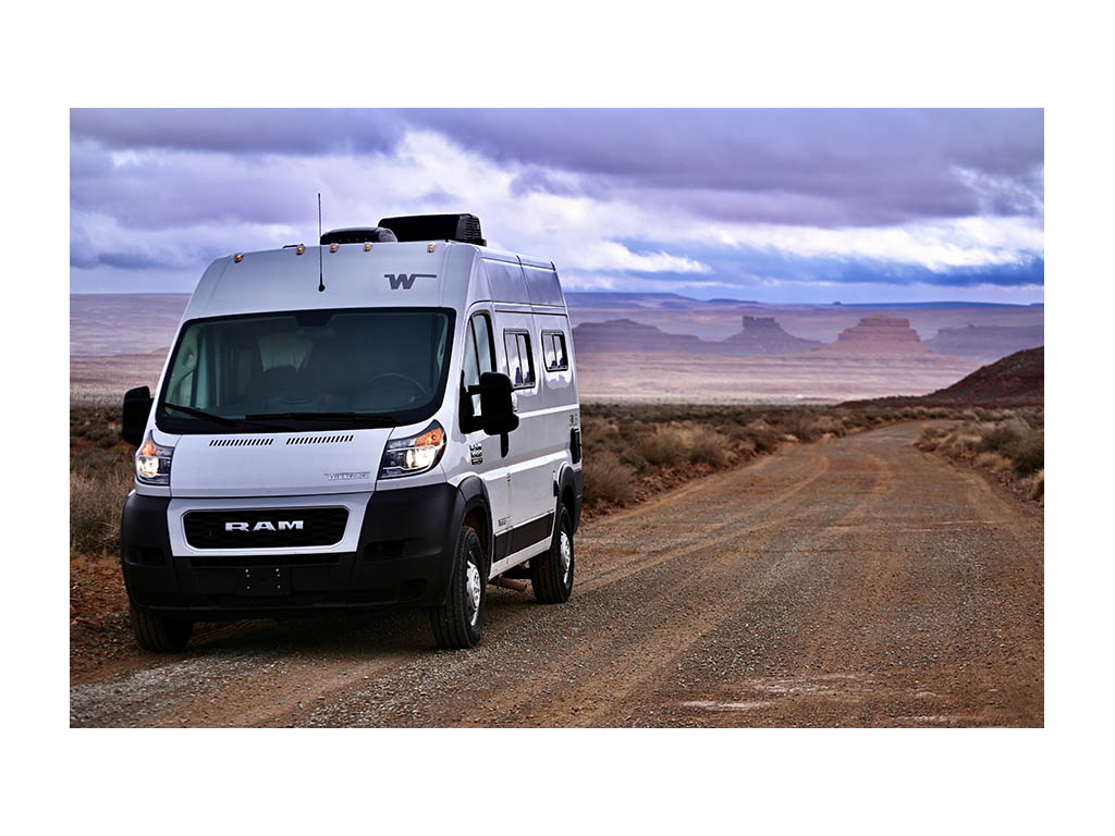 Solis Pocket driving down dirt road during sunset