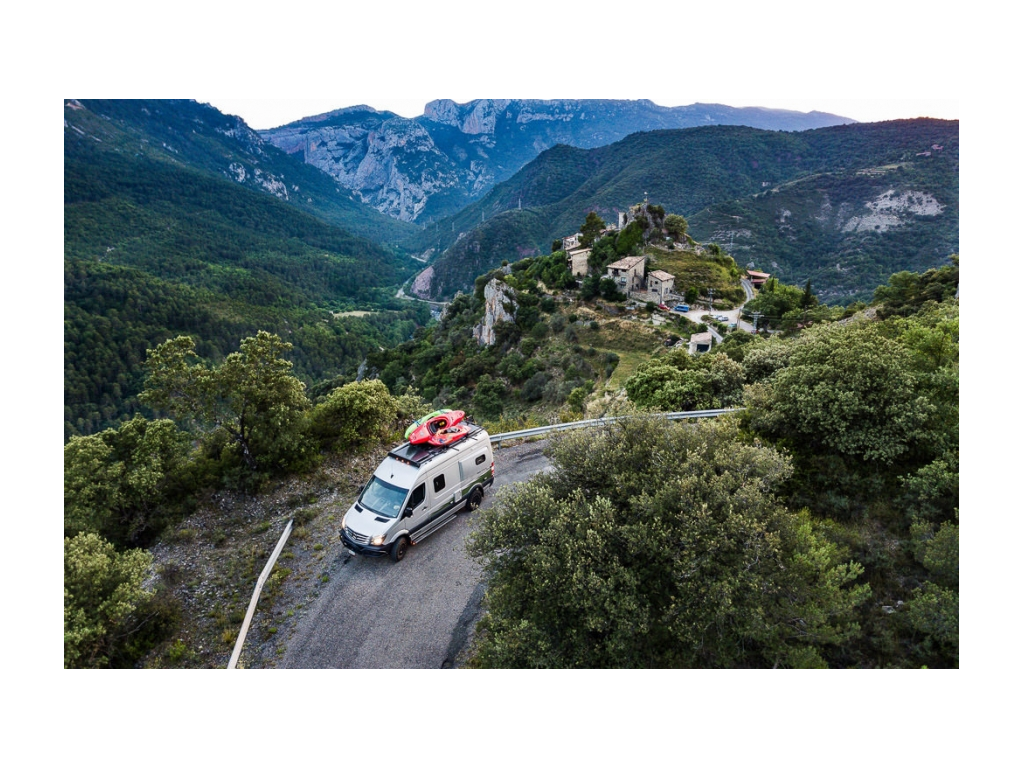 Revel driving down road with kayaks on top
