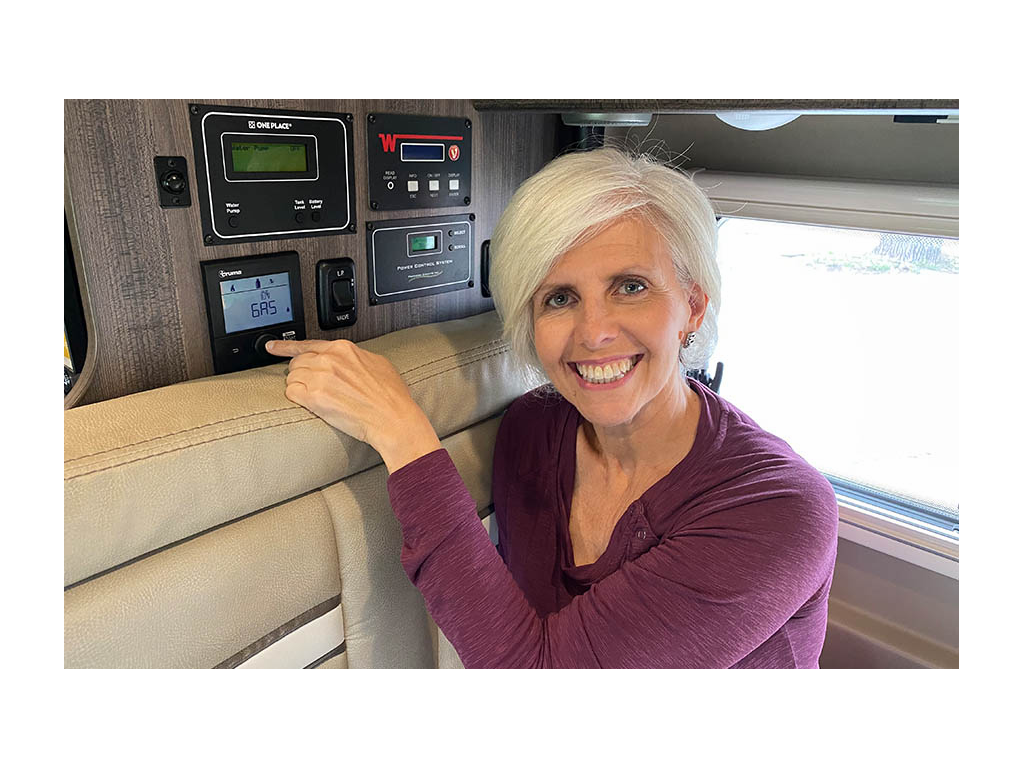 Chris pointing in Truma Combi Eco Plus Heating System in Travato