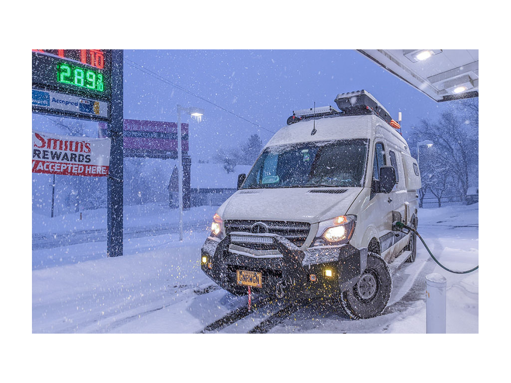 Gnar Wagon filling up at gas station in the snow