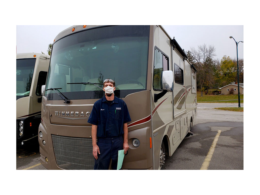 Service tech wearing mask standing in front of Vista