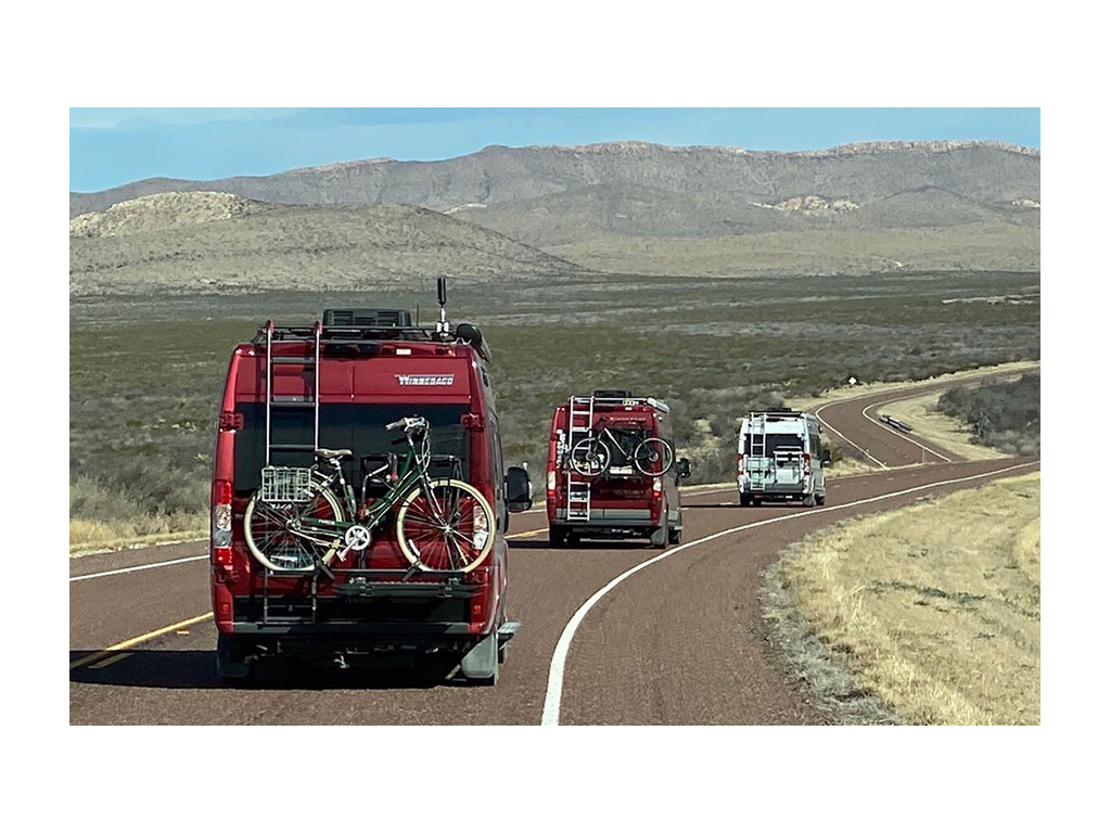 Three Winnebago Travatos driving down the road