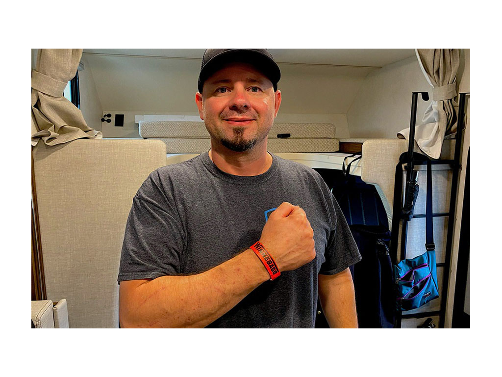 Kenny showing off red visitor band