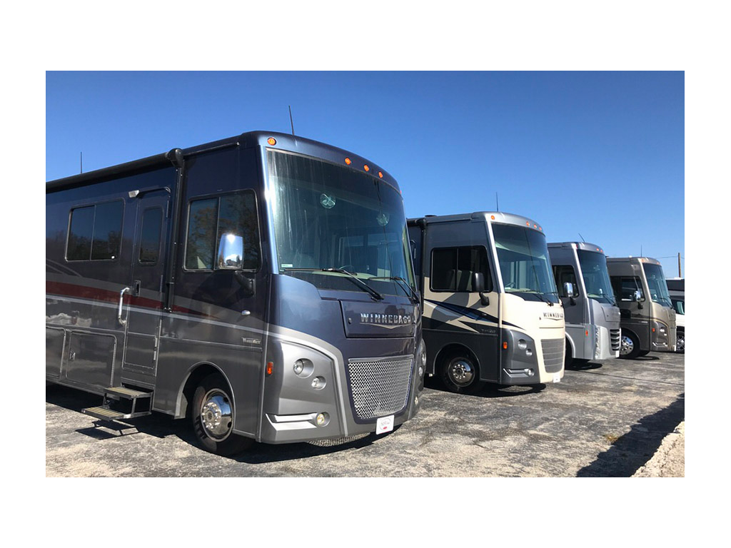 Winnebago Class A motorhomes lined up on dealer lot