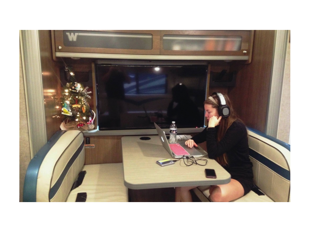 Alyssa working on her laptop at the dinette.