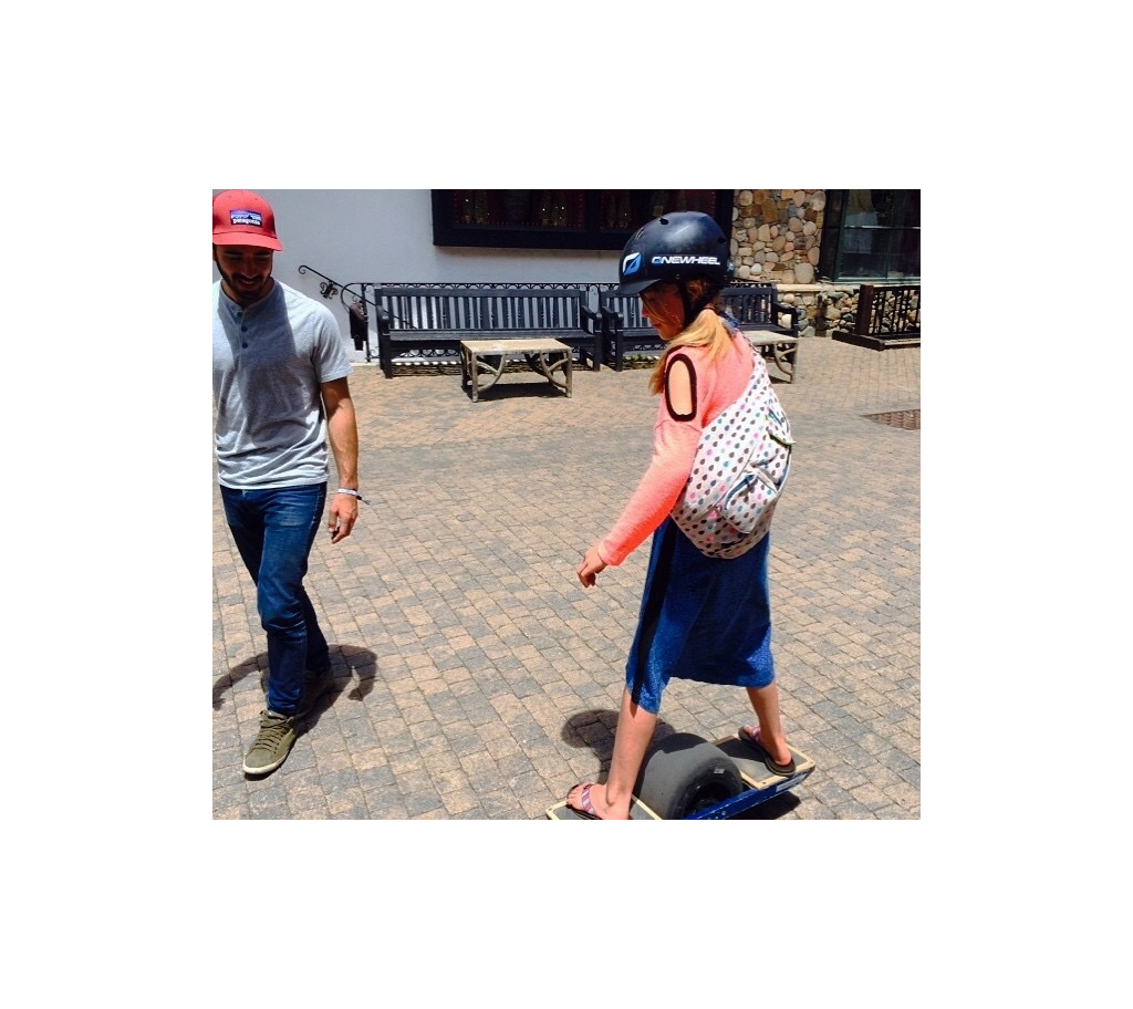 Abby trying out a one-wheel skateboard.
