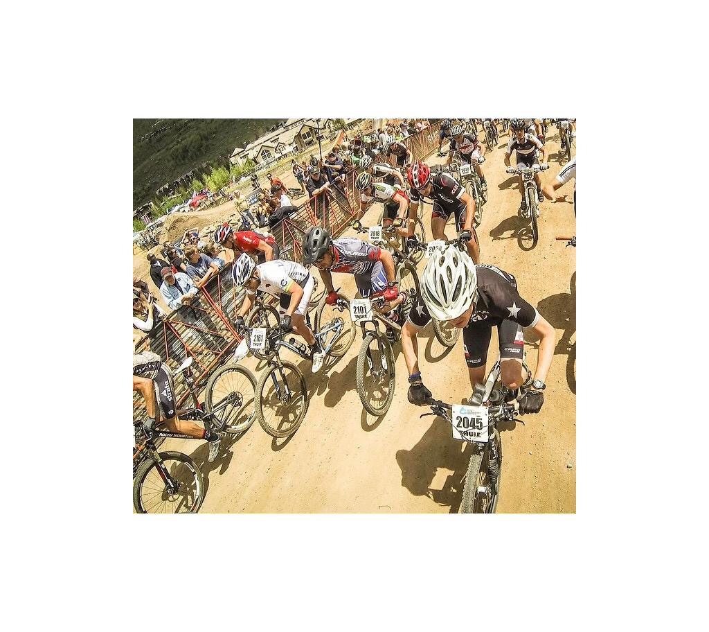 Dozens of bikers riding on dirt