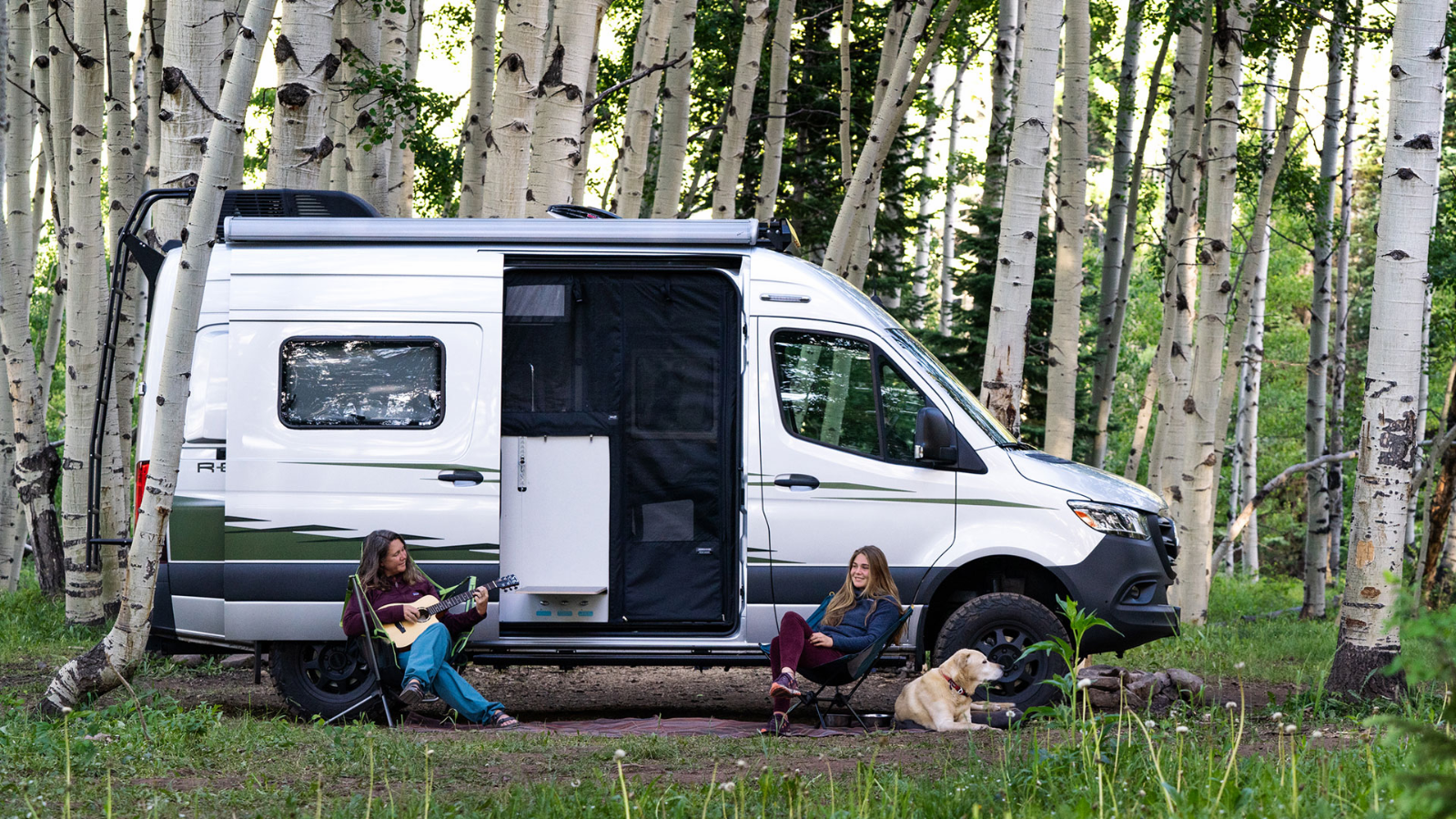 Winnebago Revel passenger side exterior with sliding door open and side screen door deployed