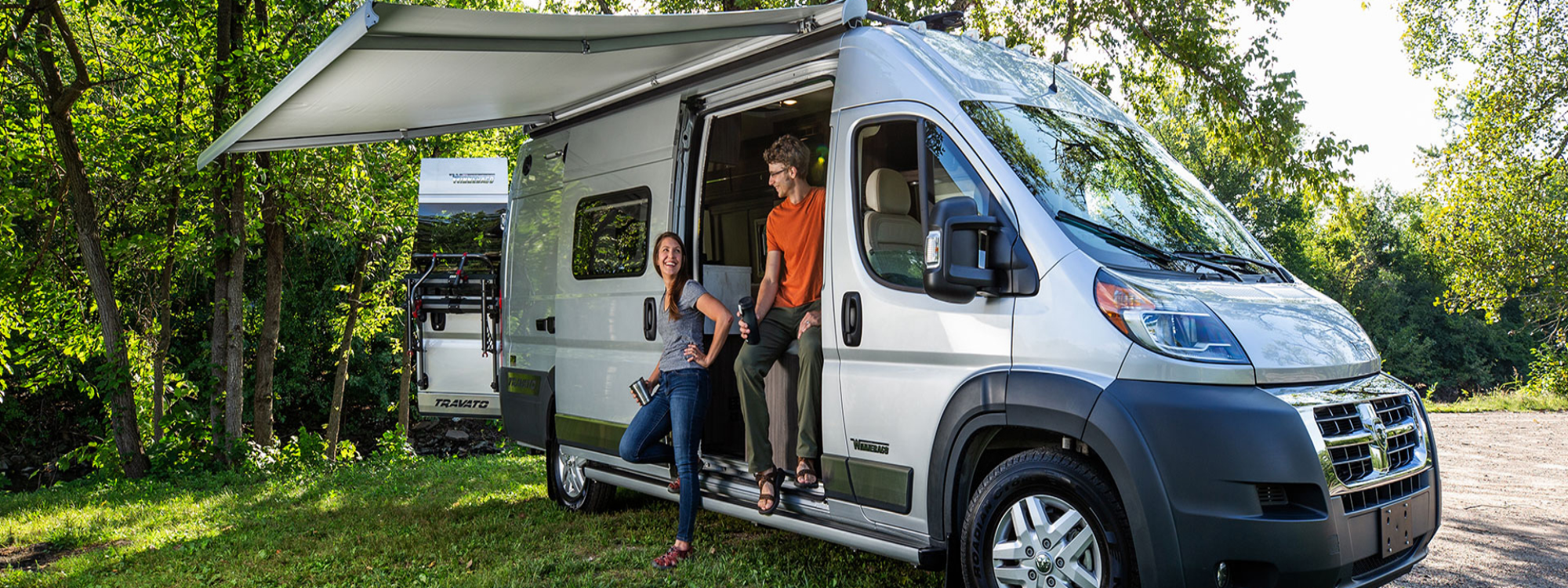 Couple hanging out inside their Travato camper van