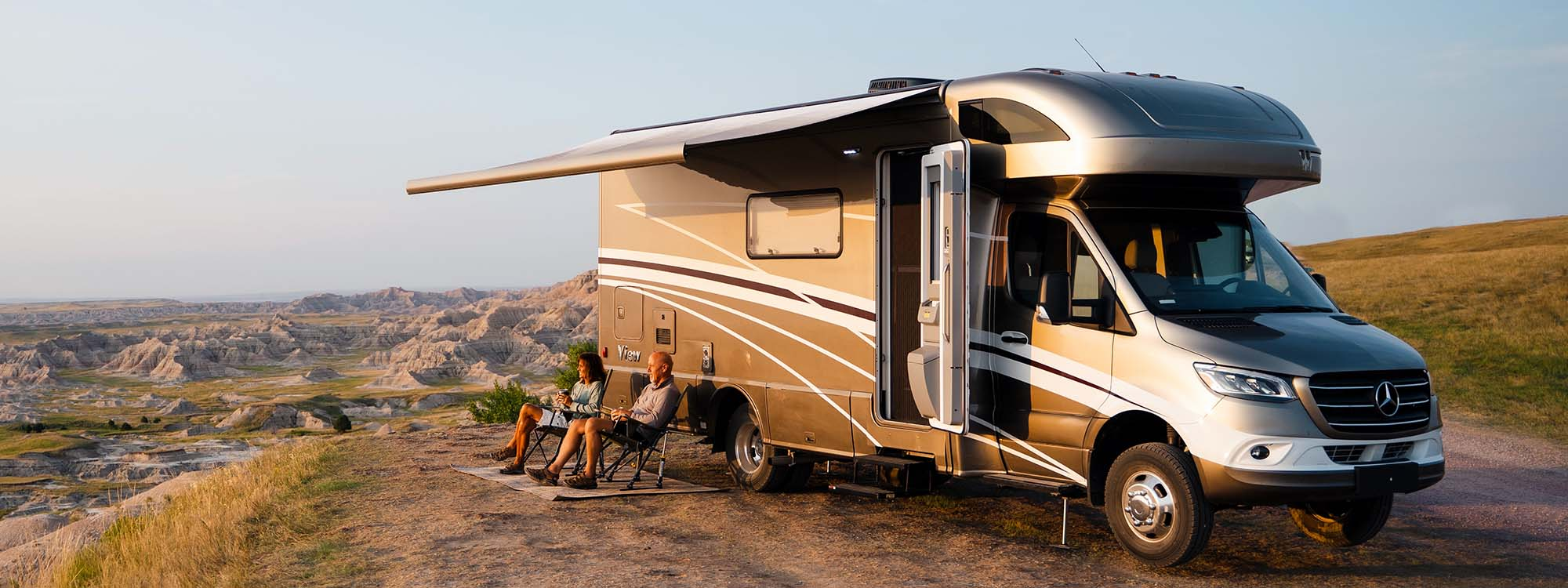 Couple lounging outside their View motorhome