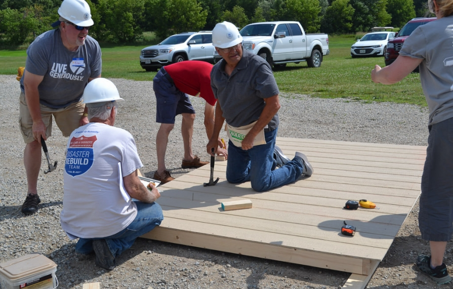 A group of RV Care-A-Vanners building part of the shed