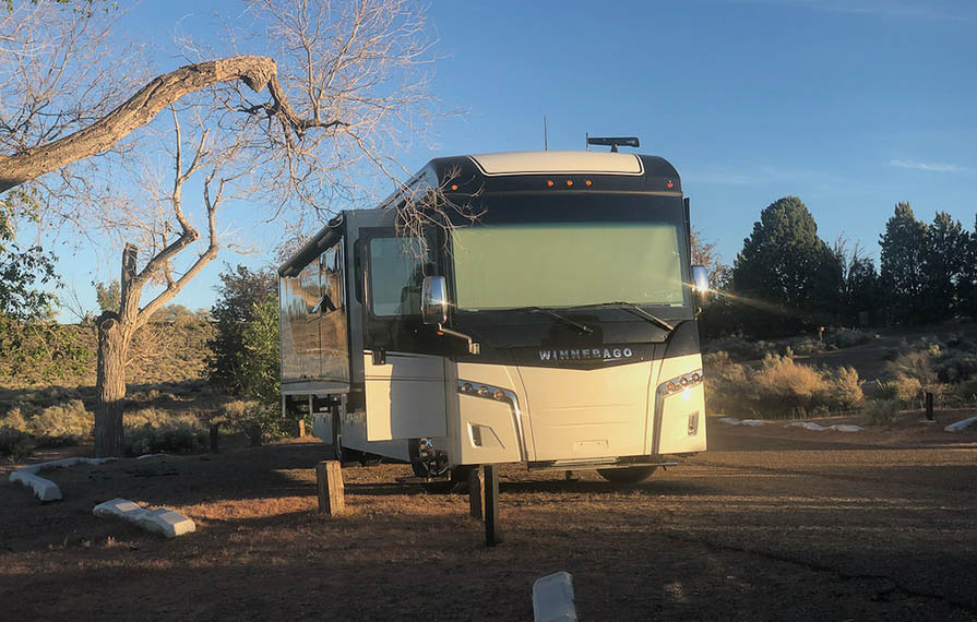 Black and white Horizon parked in gravel campsite in Wahweep