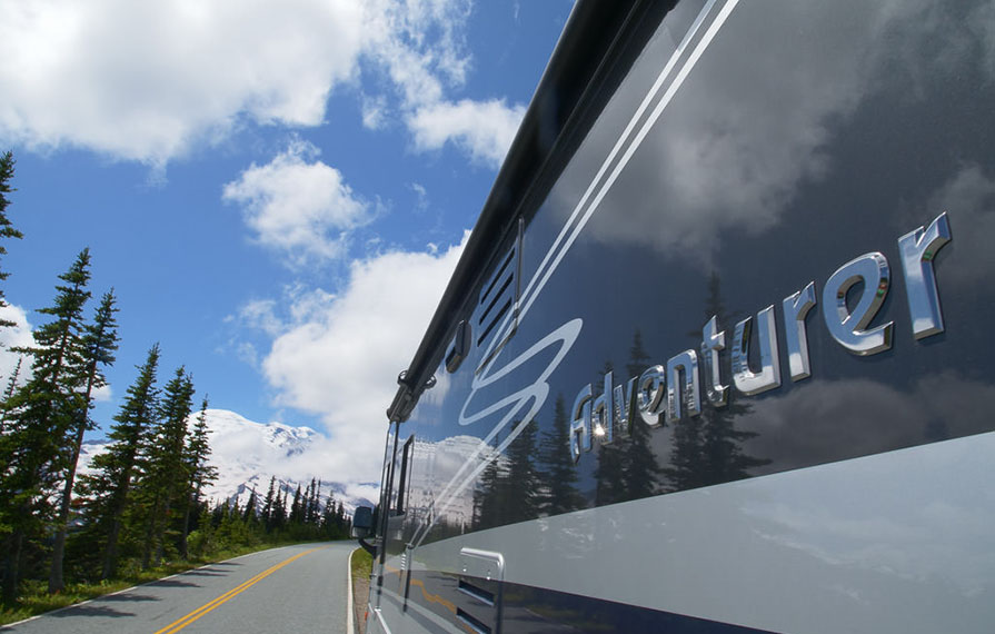 Winnebago Adventurer parked on the side of the road with Mount Rainier ahead