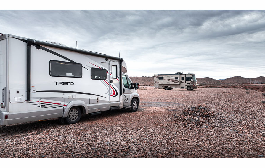 Trend and Vista parked in gravel lot