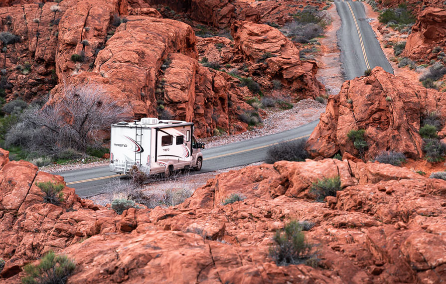 Trend driving through red colored rocks in Valley of Fire