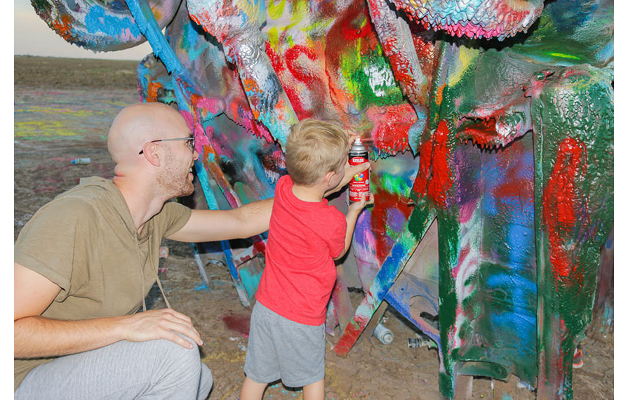 Nic with one of the boys painting at Cadillac Ranch