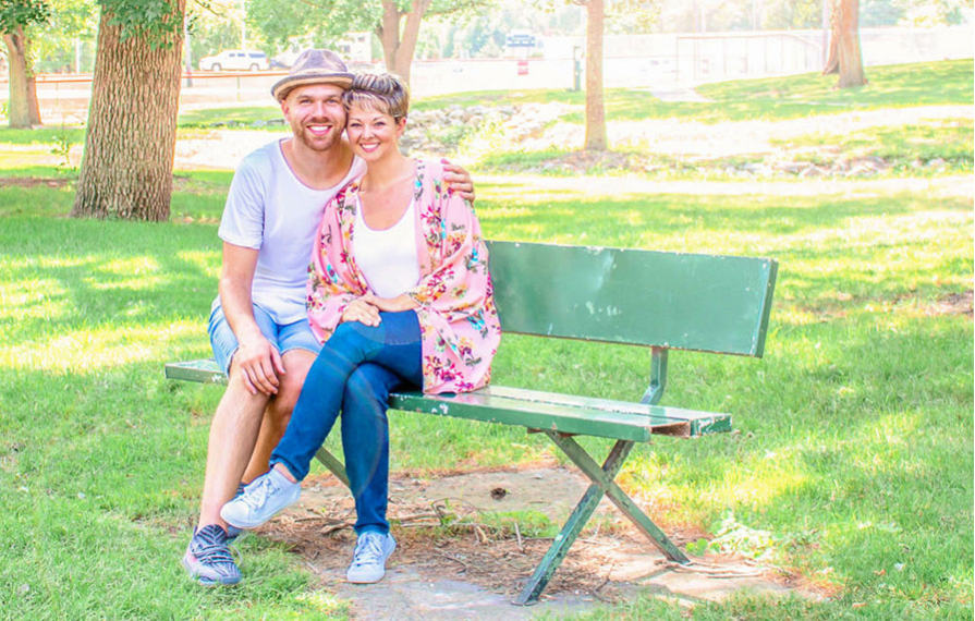 Nic and Jess sitting on a bench at a park