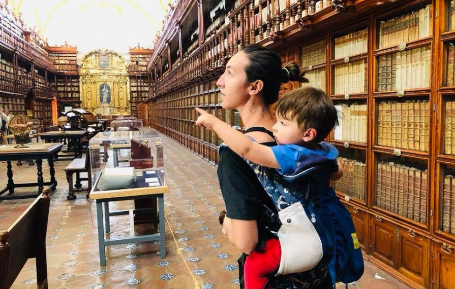Brittany with Caspian on her back in a pack touring the Biblioteca Palafoxiana